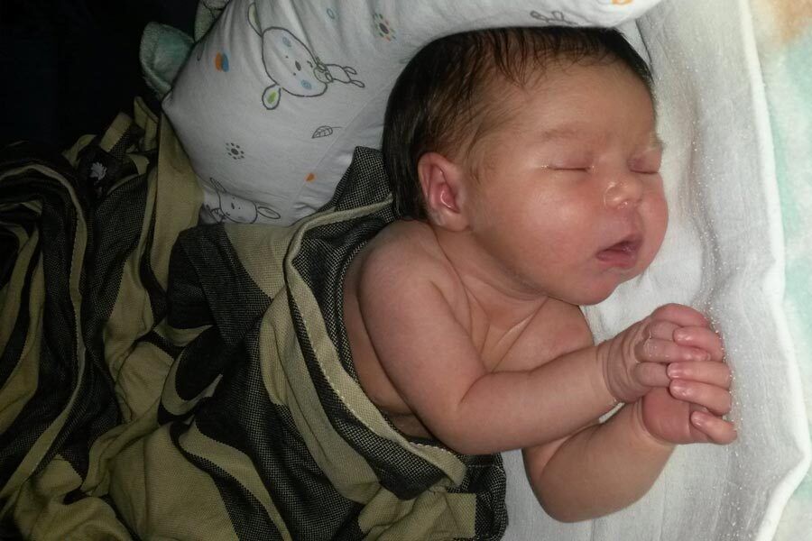 Baby Emilia sleeps in her bed.