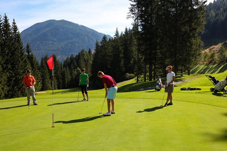 Golfers on a golf course in the Carinthian mountains
