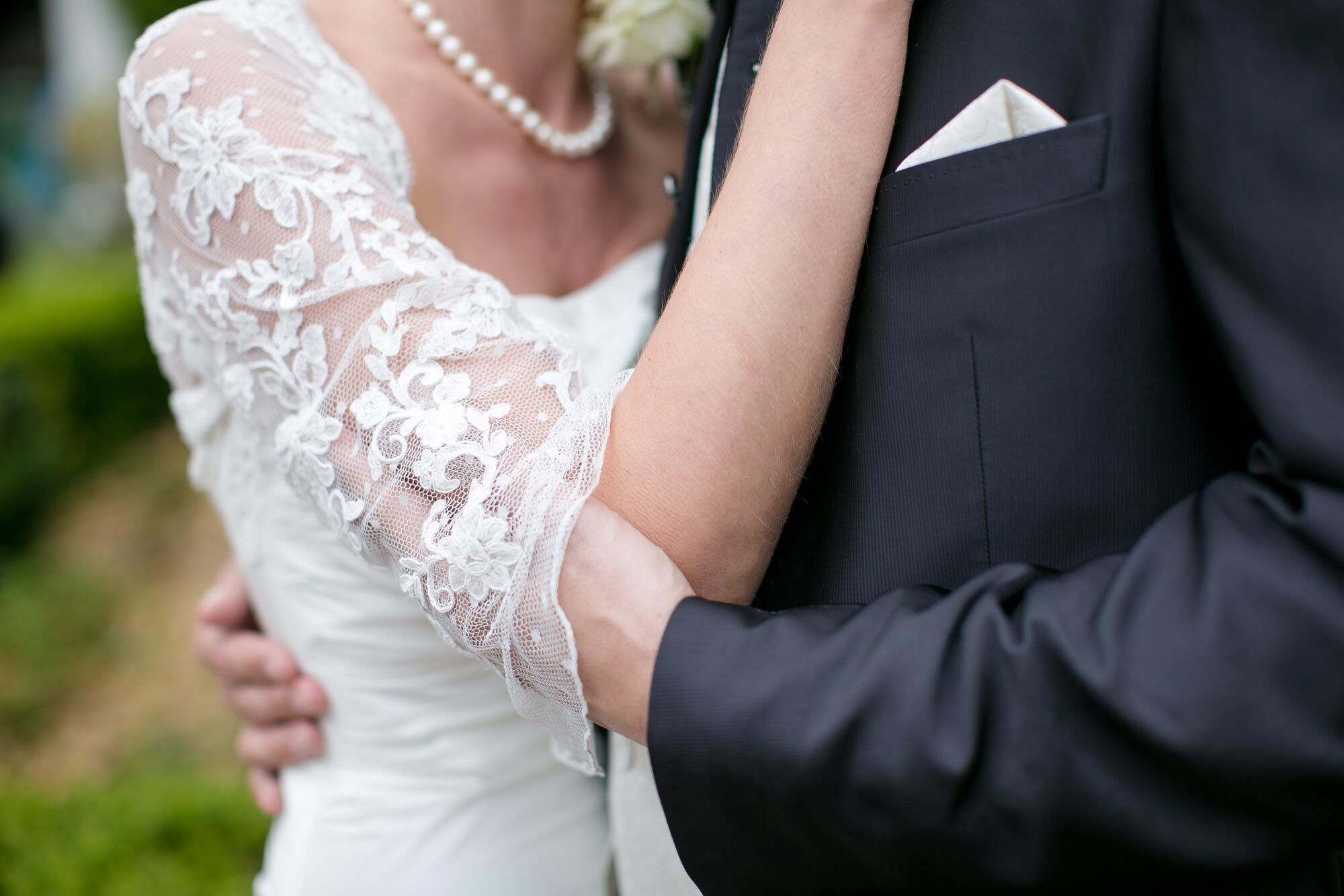 Bride and groom in love lying in each other's arms during the wedding