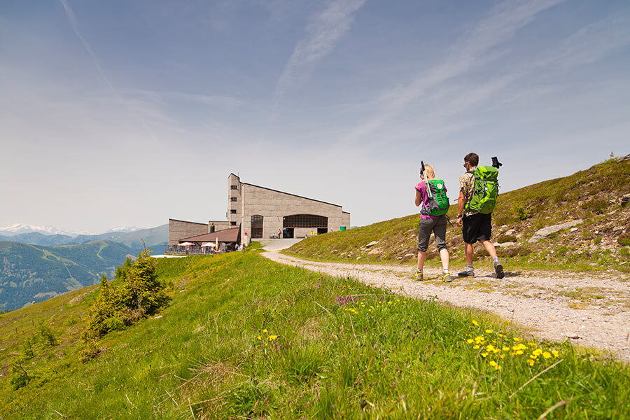 Two hikers on the way to a cable car station in the wonderful mountain landscape in Carinthia