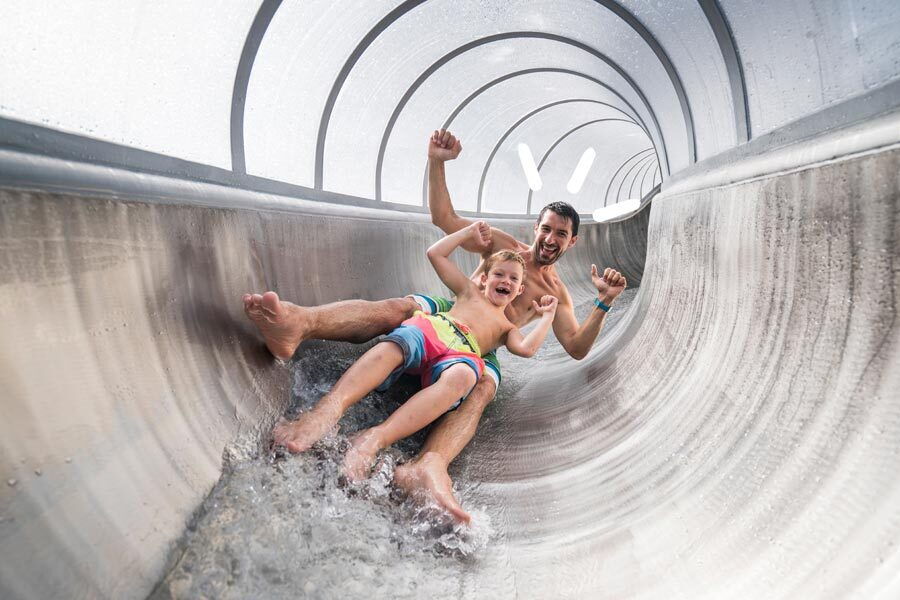 Father and son in a water slide at the St. Kathrein thermal spa