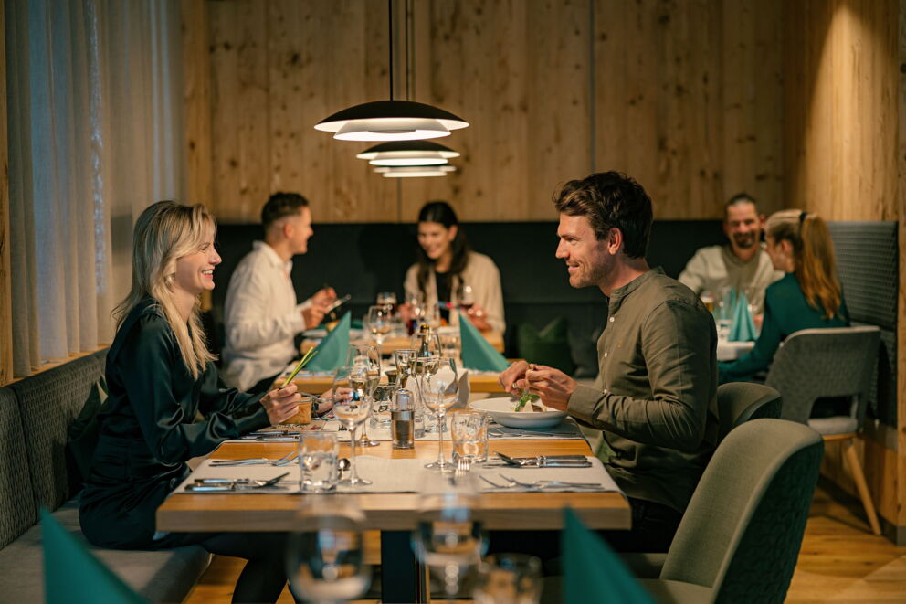 Gemütliche Restaurantatmosphäre mit Paaren beim Essen in einer Spa-Umgebung mit gedecktem Tisch