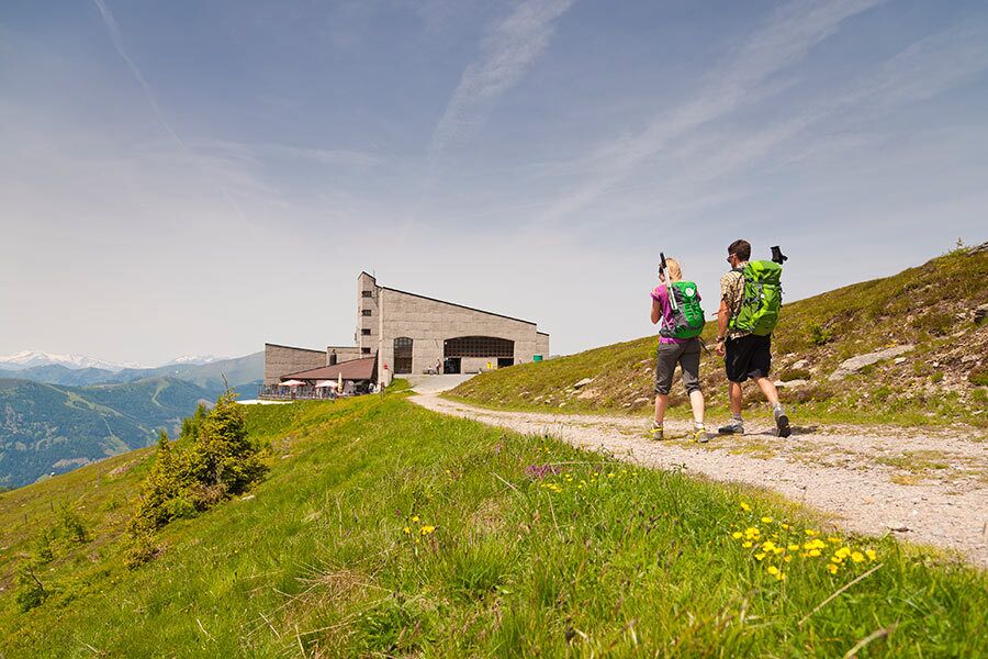 Two hikers on the way to a cable car station in the wonderful mountain landscape in Carinthia
