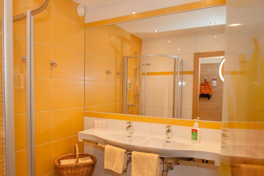 Luxuriöses Spa-Badezimmer mit Doppelwaschbecken und Dusche, hygienisch und stilvoll gestaltet