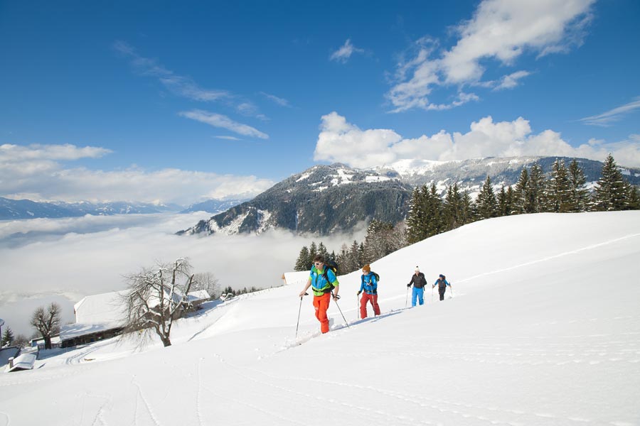 Ski tour walkers in a snowy mountain landscape in the Salzkammergut
